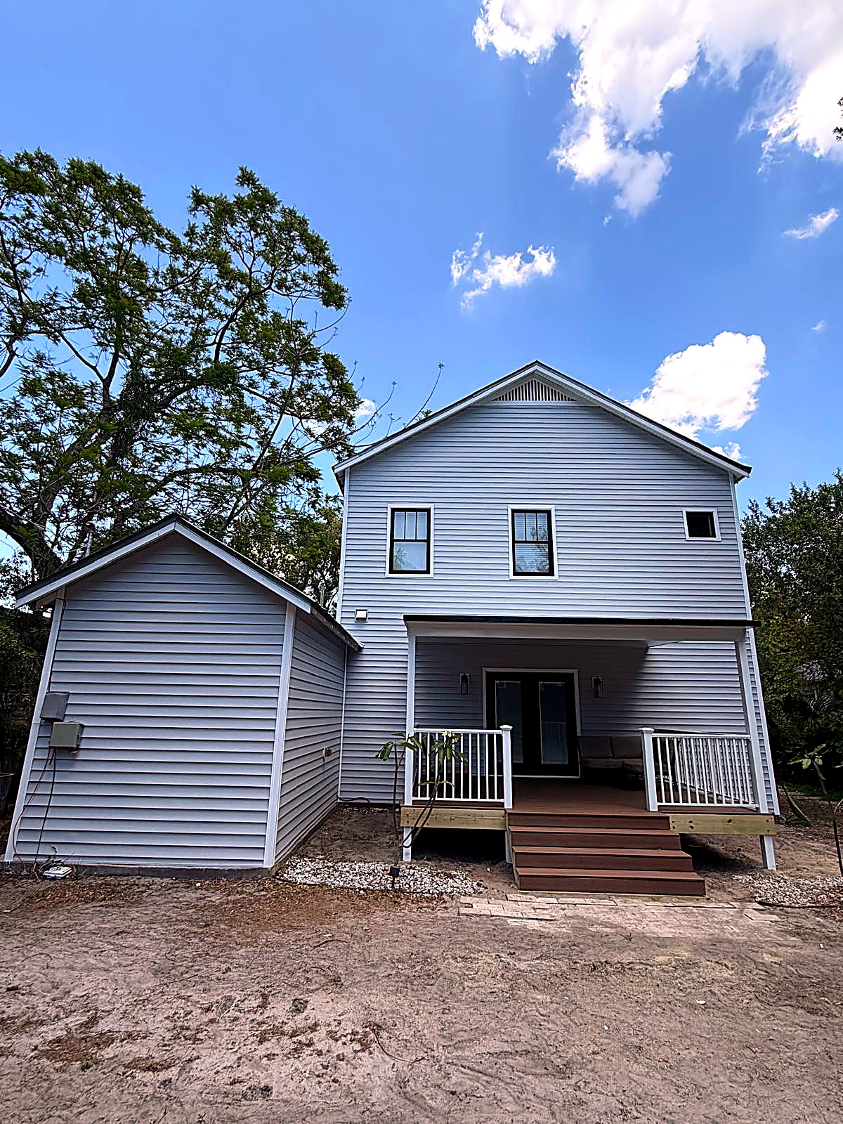 Finished vinyl siding installation on a two-story home with covered front porch — Land O’Lakes, Florida